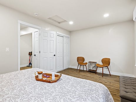 View of king bed, entrance to bedroom, sitting area and closet in bedroom