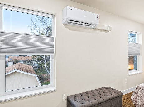 Interior windows of bedroom. All windows in the apartment are covered by room darkening, honeycomb blinds and feature top-down-bottom-up that are easy to use. Also, apartment is heated and cooled by mini splits that guests have full control over. 