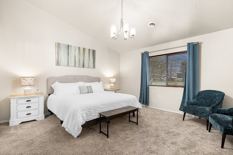 Main floor Master Suite with luxury Saatva king bed, dresser, walk in closet, hamper, and hangers, and blackout curtains. Golf course view.
