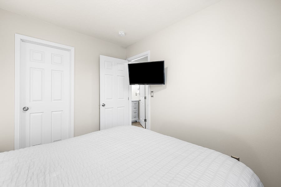 32 Smart Roku TV on long arm swivel rotates from hall into this bedroom.