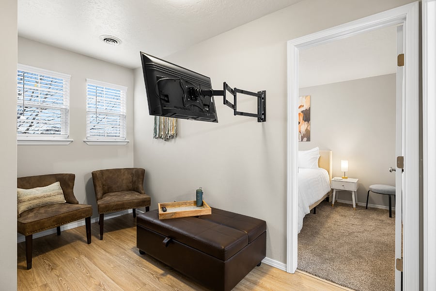 Flex space between upstairs bedrooms with 32 Smart Roku TV on long arm that swivels to be seen from sitting area or bathroom. XL ottoman opens into adult worthy twin bed with comfortable mattress. Additional premium egg crate pad available to make it extremely comfortable. With owner assistance, this bed can be moved into the upstairs bunk room or office/flex room downstairs,