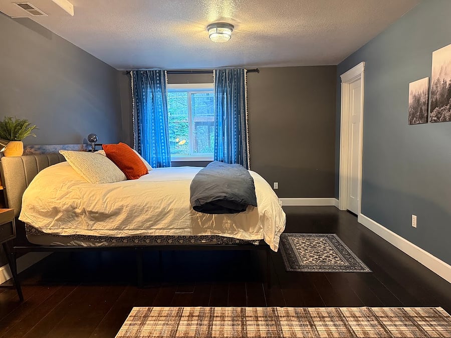 Primary bedroom with his and hers walk-in closets located on either side of art wall. Rooms come with extra space heaters for colder days. Heat is controlled by the owner. Heat is kept at 72 degrees.