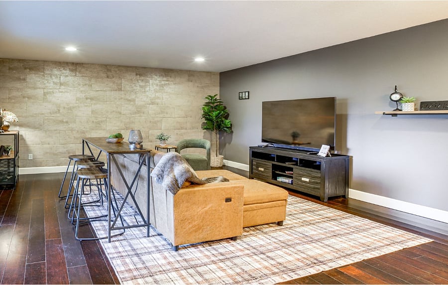 Main living area with faux leather storage sofa.  No dining room, so we have placed a bar to the left that has power to it. TV is a smart TV.
