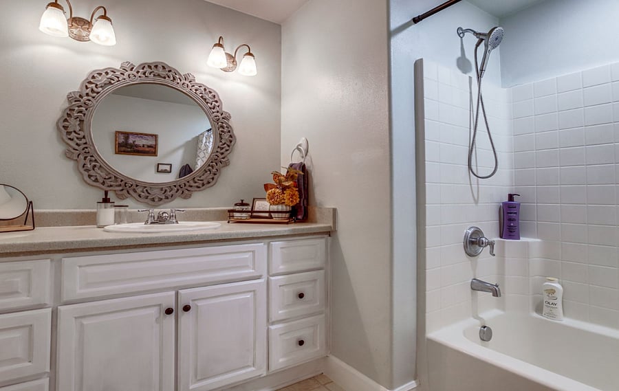 Primary bathroom, tub and shower unit and ample storage.