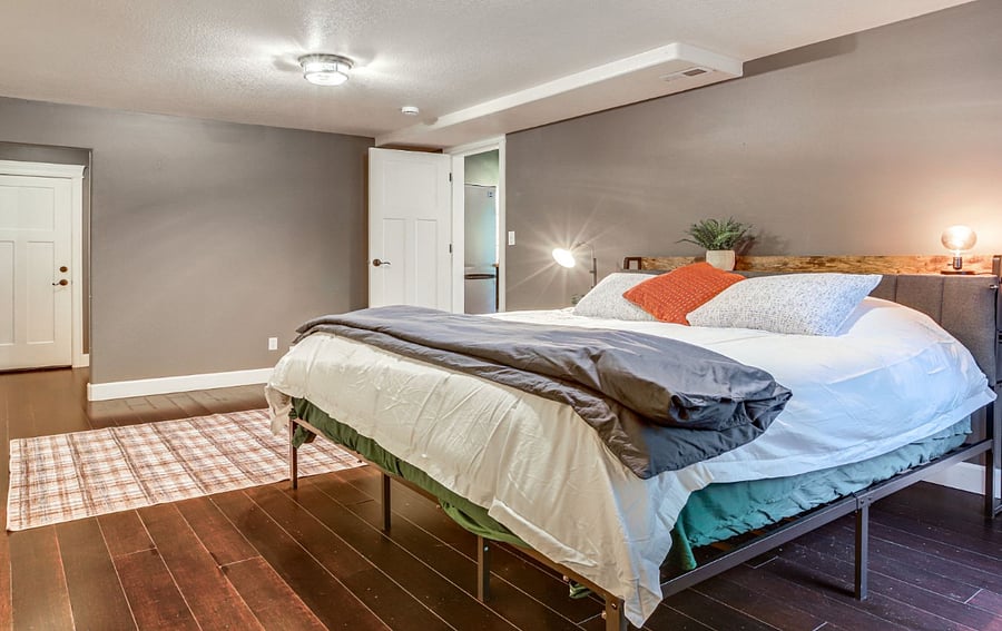 Primary bedroom with king bed, memory foam mattress and hallway is beyond to laundry and in-suite bathroom.