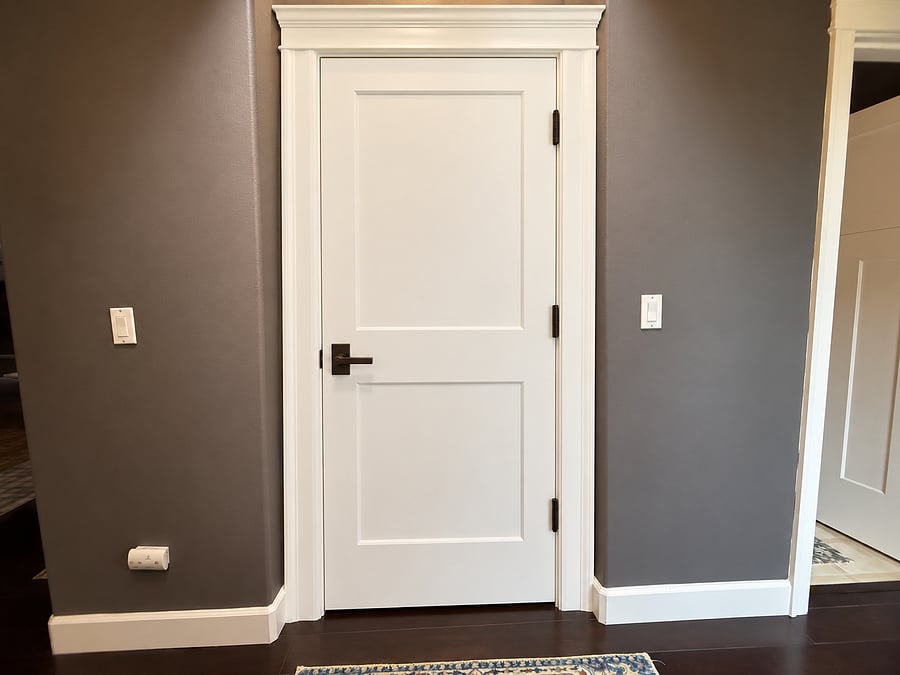 This is the solid wood door (left) to the unit stairway above. It will be padlocked from the other side. Upper unit stair door will be deadbolted. main bathroom to the right.