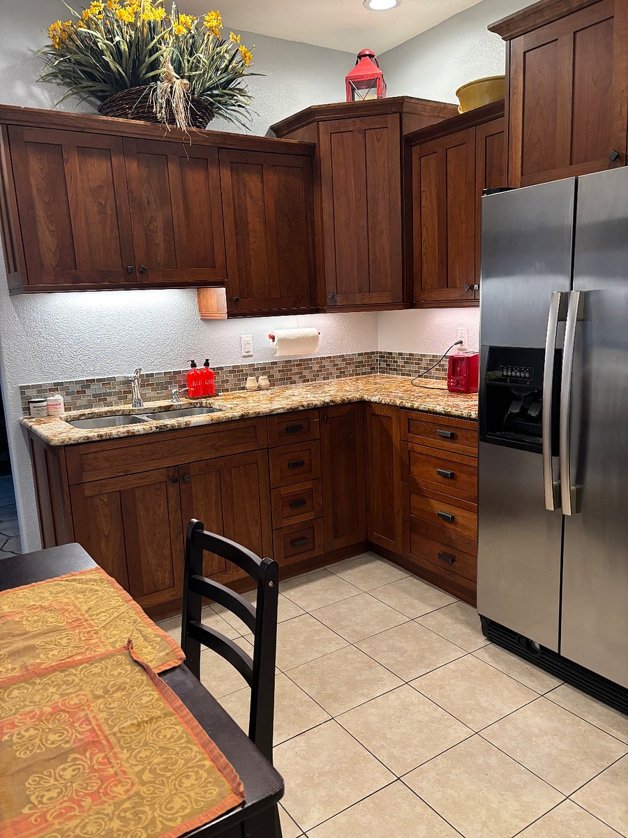 Kitchen with refrigerator, toaster, sink, cabinets