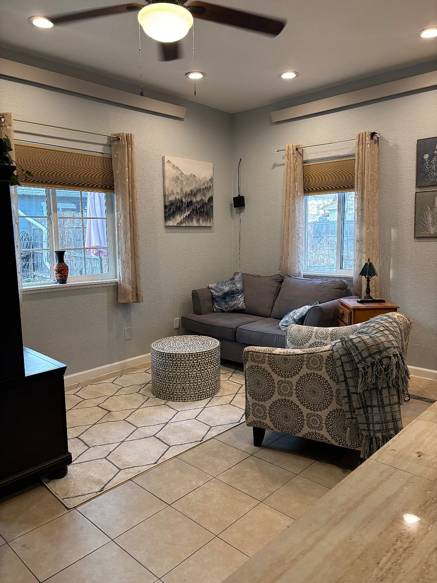 Living room area with loveseat, chair and end table.