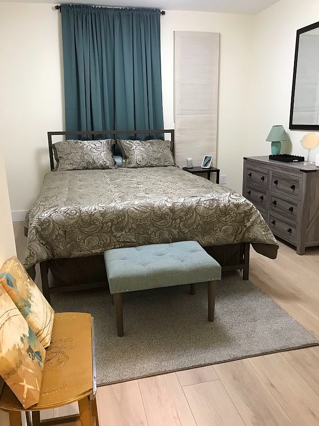 Large bedroom has queen sized bed, and large walk in closet with all the cozy comforts