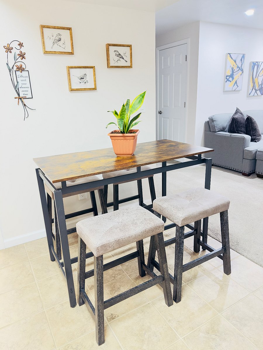 Cozy dining area with a modern high top table and seating for four. Great for meals, coffee, or light work. Open layout flows into the living space, creating a bright and comfortable spot to gather and relax.