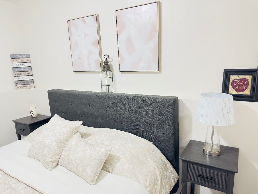 Inviting second bedroom with a comfortable bed, plush pillows, and soft neutral bedding. Matching nightstands with lamps provide warm lighting, creating a calm and relaxing space for a restful stay.