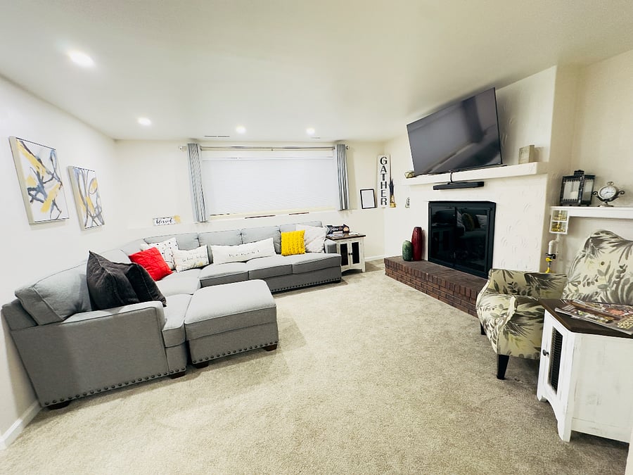 This inviting living room offers warm tones comfortable seating and the cozy glow of a fireplace. It is the perfect place to relax, have family and friends game night, watch a movie, enjoy a quiet moment, or read a good book after a day of exploring.