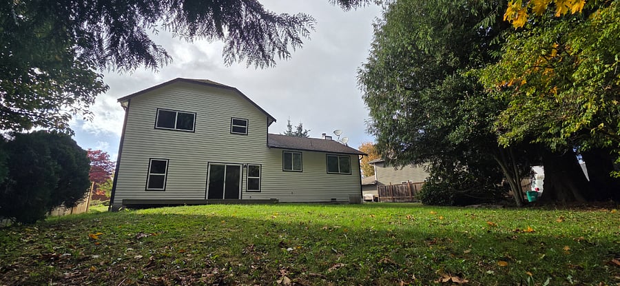 Large partially fenced backyard