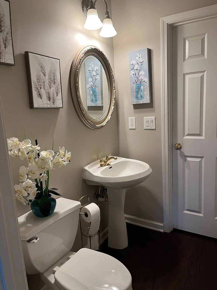 Down stairs powder room which features an enclosed tub and shower .