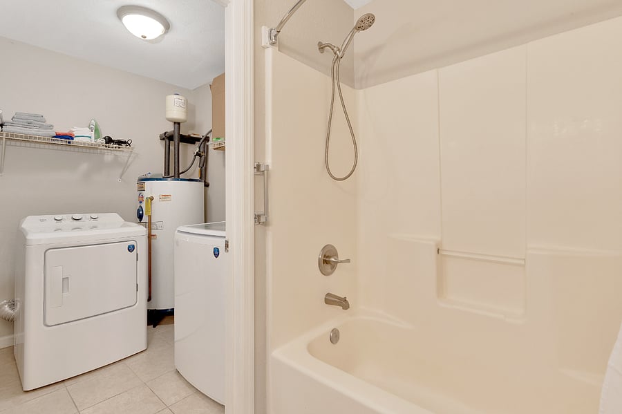 Full size bath connects to the laundry area