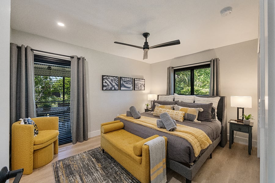 King suite with plush bedding, bench, and a cozy reading chair. Ceiling fan and room-darkening shades for a great nights sleep!