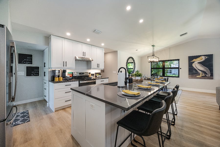 Large island with breakfast bar seating. The dining table sits right beside it for easy family meals.