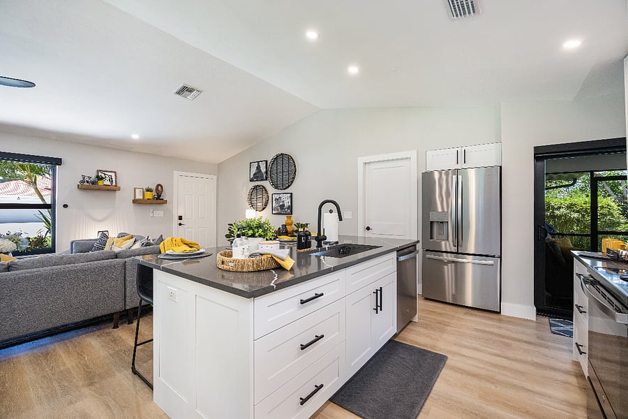 Spacious prep island with deep sink, dishwasher, and fridge nearby. Open layout lets you engage with everyone while cooking.