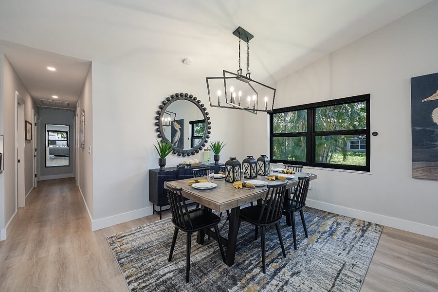Bright dining area with a wood table, six chairs, and a sleek sideboard. A comfy spot for shared meals and game nights.