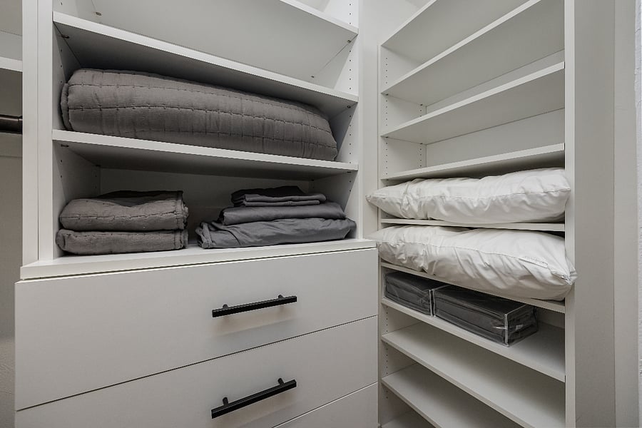 Walk-in closet with built-in shelves, extra pillows, blankets, hangers and spare linens. Plenty of storage for longer stays.