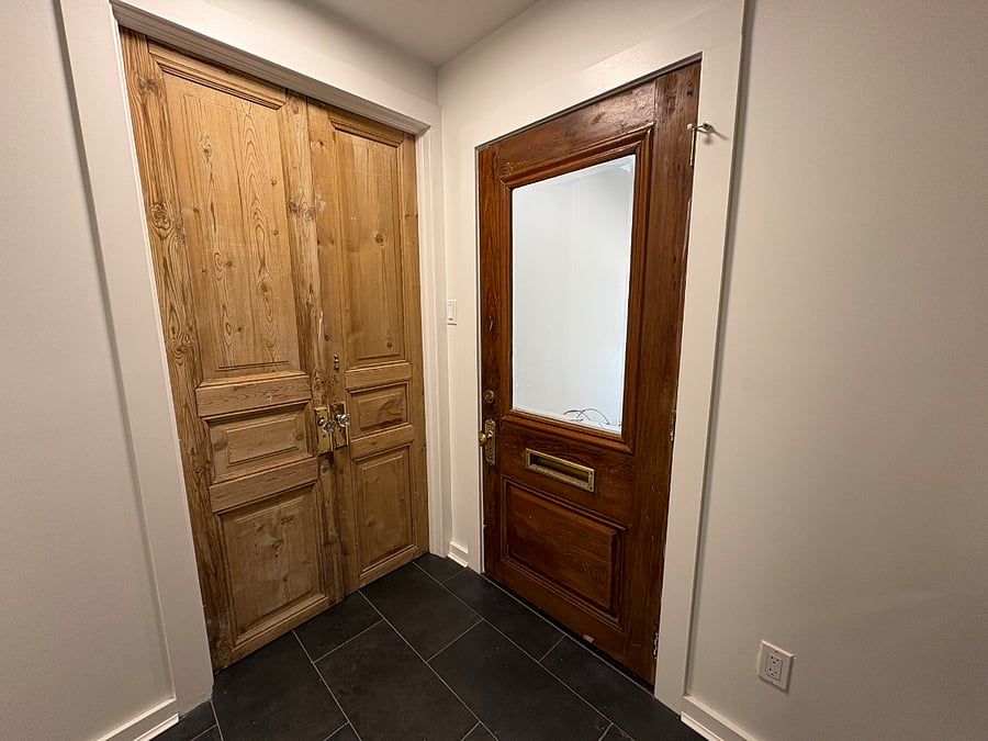 View from the laundry area- to the right you will enter the kitchen and through the historic french doors you will enter king bedroom.