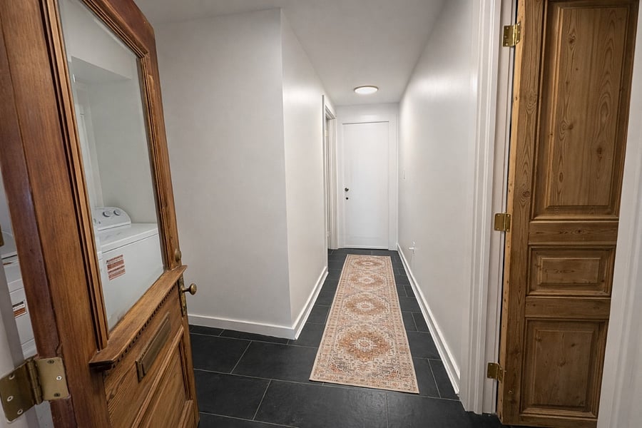 Hallway behind the kitchen has a washer and dryer located here. To the right you will find the king bedroom. The bathroom is located towards the end of the hallway.