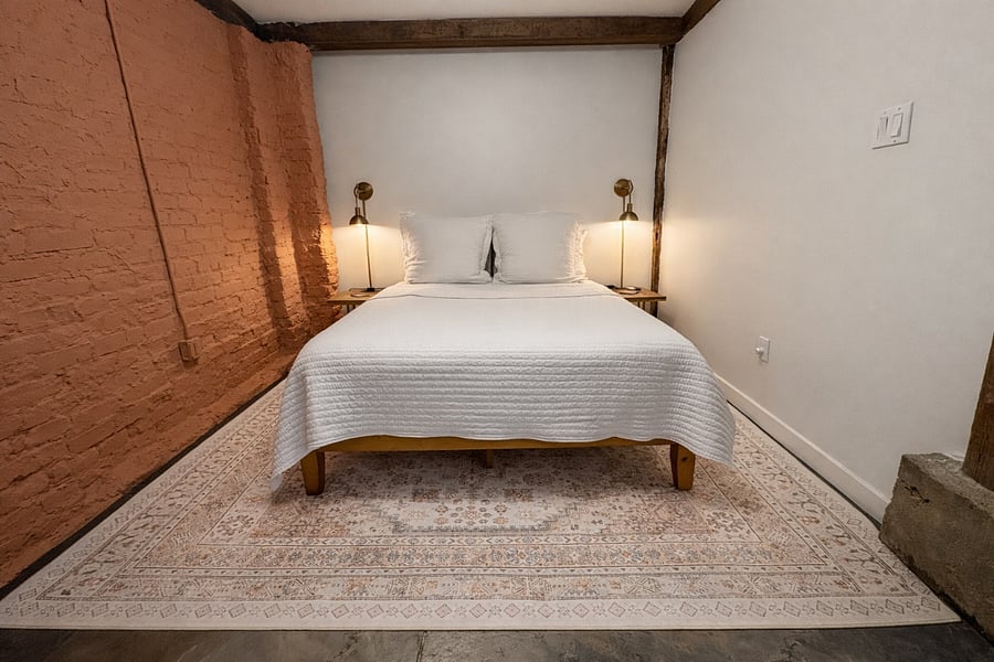 This bedroom is located to the right of the kitchen and has a queen bed that has a medium feel. This room has a private full bath.