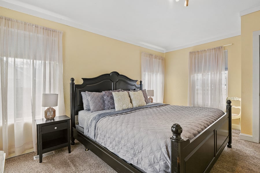 Primary bedroom, king bed, closet, dresser, 4 windows with black out shades, 