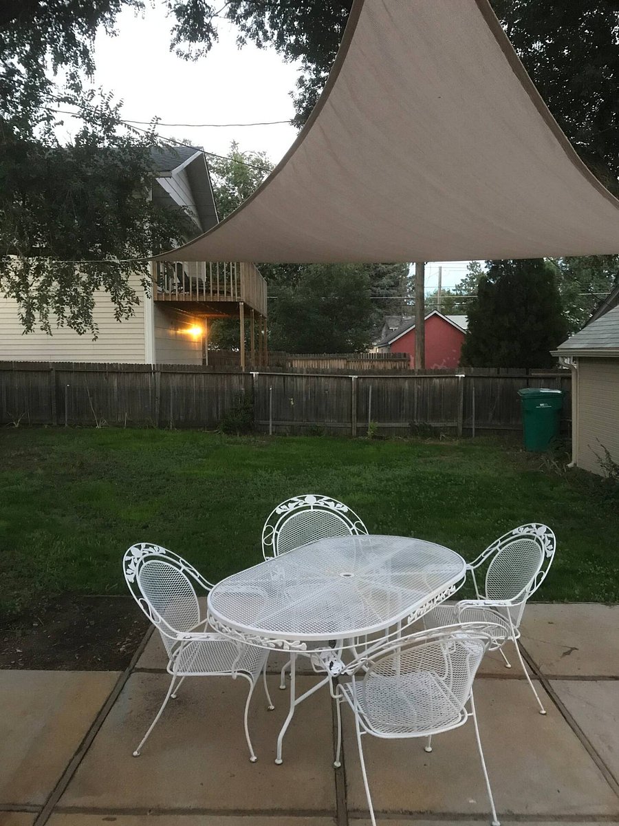 backyard with garage for bicycles and outdoor supplies. 