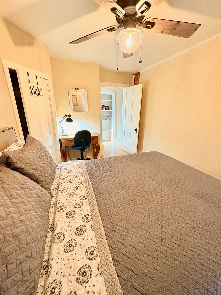 #3 bedroom with walk in closet, desk, and queen bedroom with view of the back yard. 