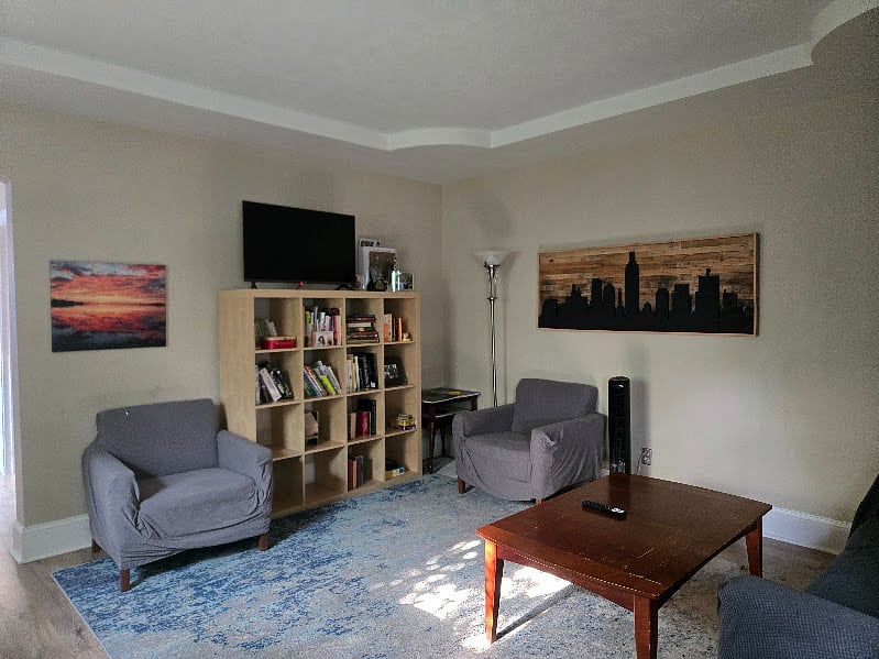 Living room features a smart tv that is not too large. 