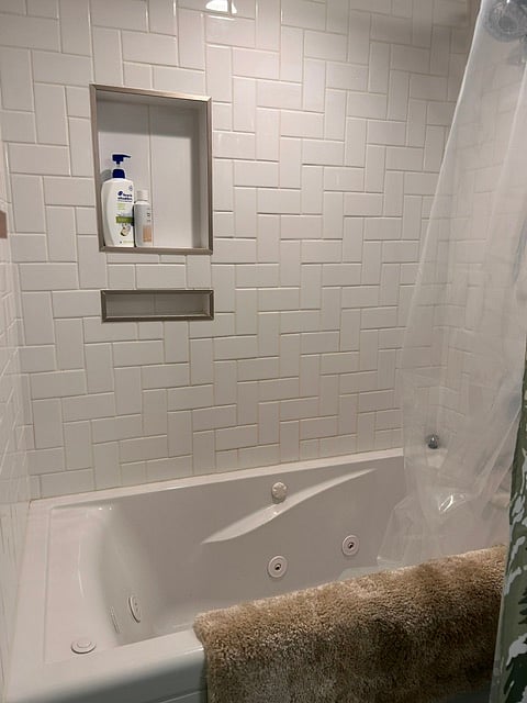 Spacious shower with jacuzzi bath tub. 