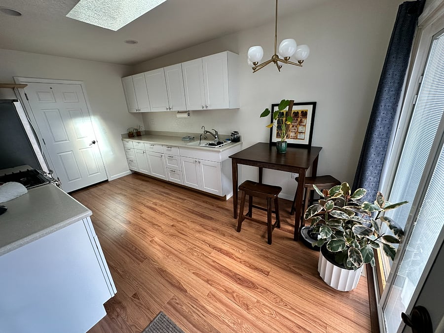 Bright, airy kitchen with skylight and sliding door to the outdoor deck. Ideal for long-term stays.