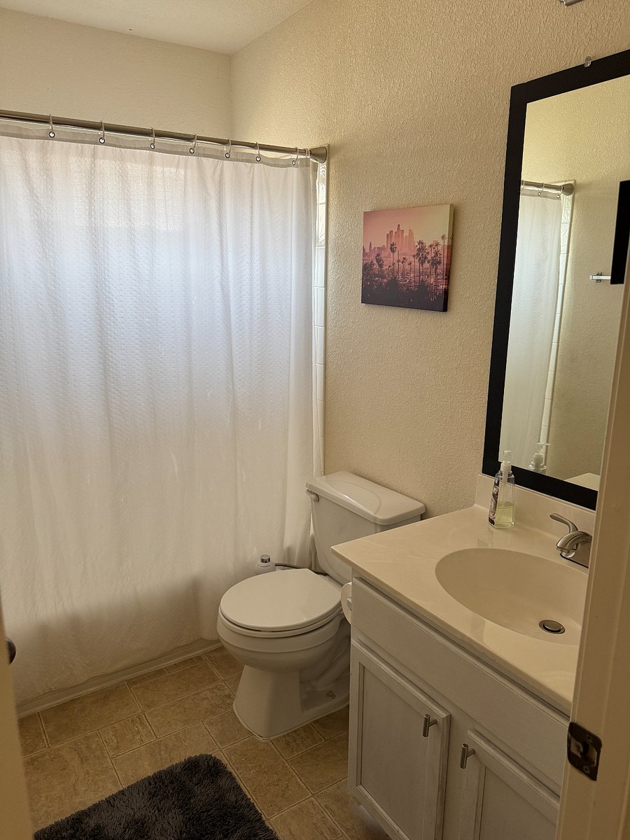 Private bathroom with clean shower and fresh towels.