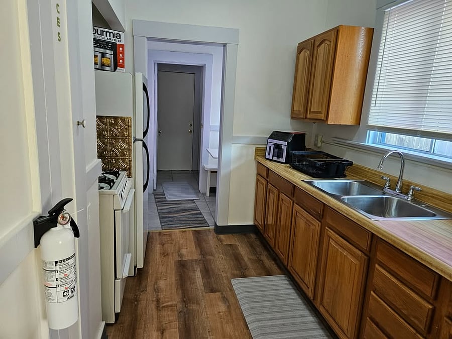 ully equipped kitchen with cookware, utensils, and appliances