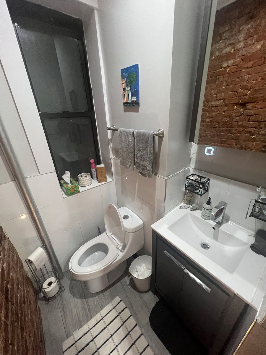 Very clean bathroom with storage space for face products and more.