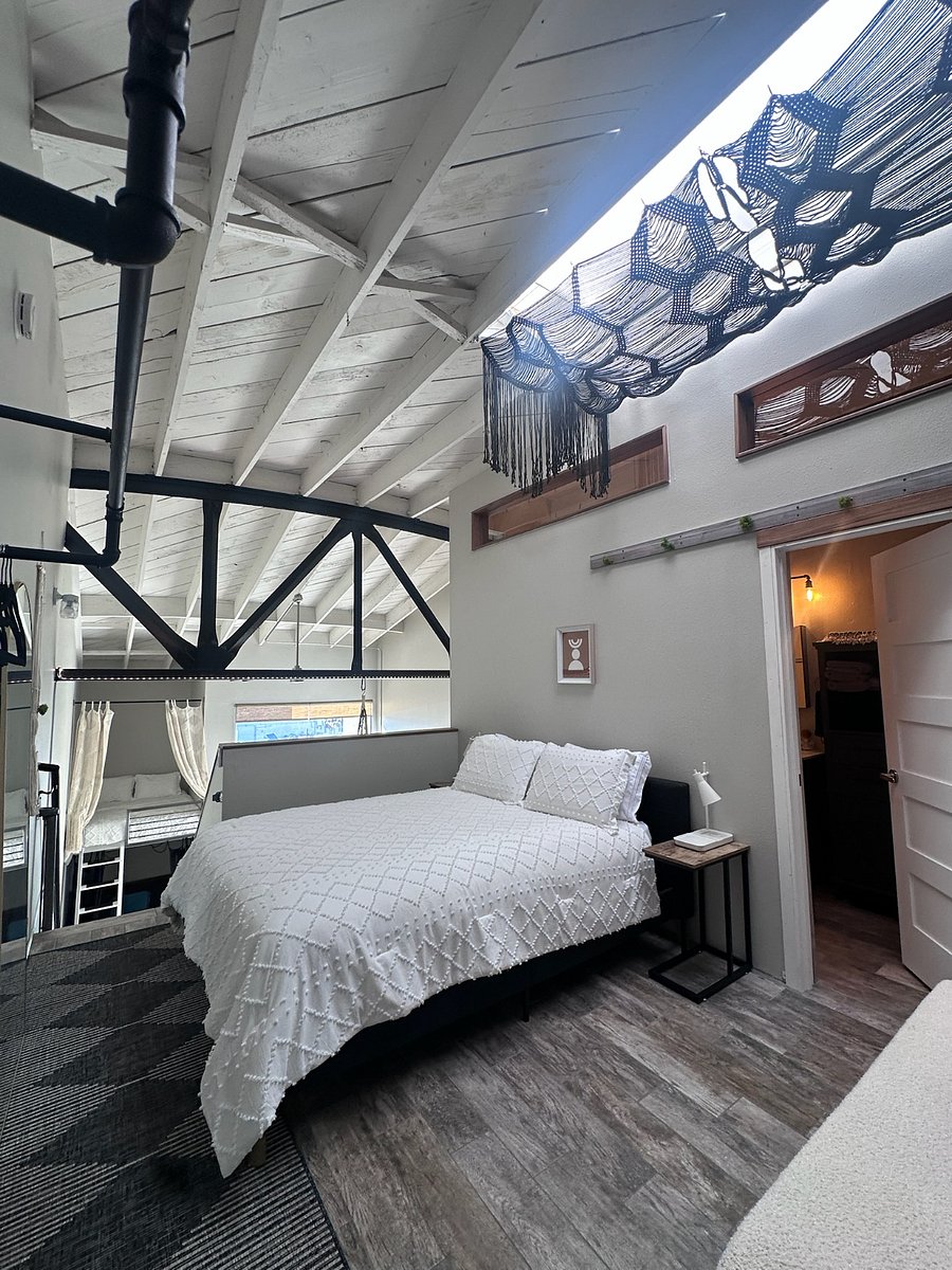 Queen size bed in loft area with view of the bay. All windows have a pulldown bamboo covering by chain pull to open and close for privacy.