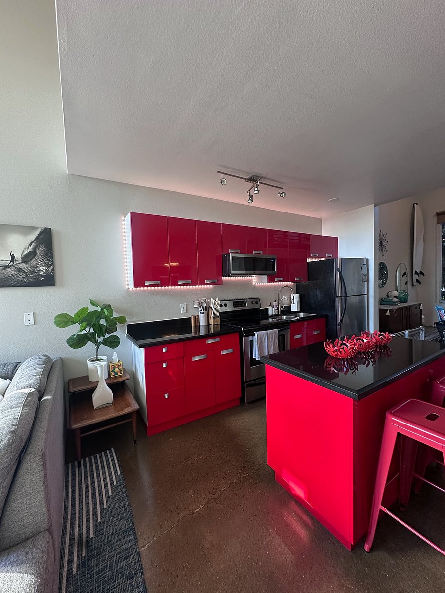 Full size kitchen with under cabinet lighting and kitchen island with seating.