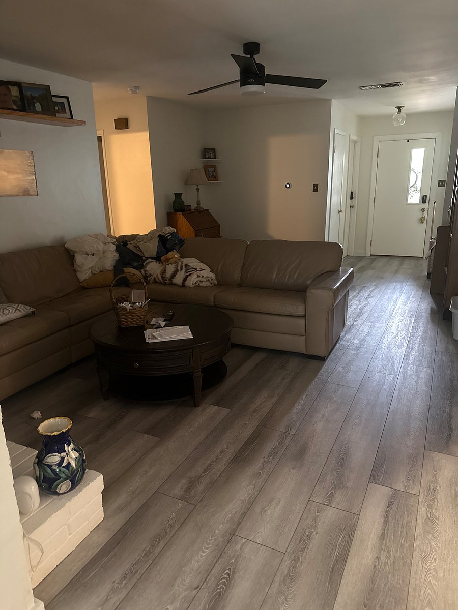 Shared space wth fireplace in front of the couch. TV mounted on the wall above fireplace.