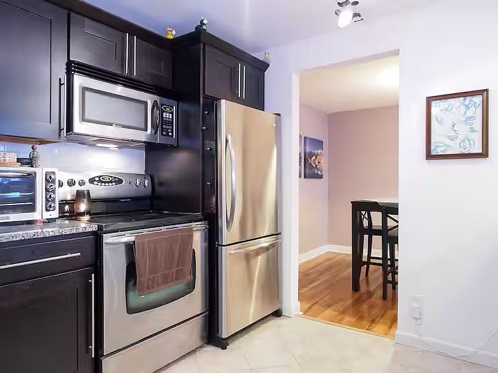 The custom kitchen is large and well-stocked with cookware, herbs, and cutlery.