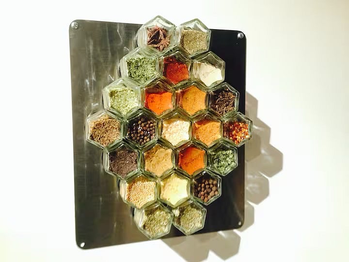 The kitchen is well-stocked with cooking vessels, utensils, spices, and common pantry items.