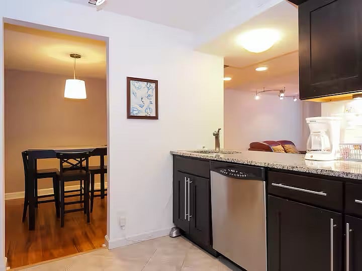 Custom kitchen opens to dining and living rooms. You can prepare a fantastic, or even a mediocre meal while talking with your guests! Or opt to order a fairly decent pizza or sub from the restaurant right inside the building! Endless possibilities