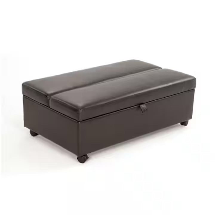 Additional bed folds away into a leather ottoman.