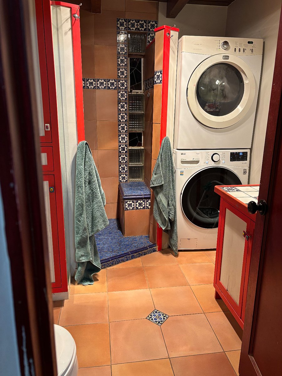 Bathroom with shower, toilet, sink, washer/dryer. Heated floor