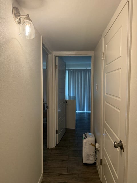 this is the view of the upstairs hallway with the dehumidifier on the floor