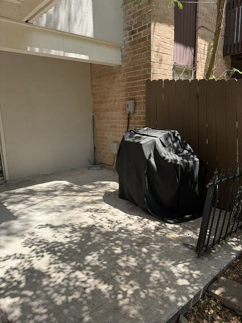 another angle of back patio with brand new charcoal grill