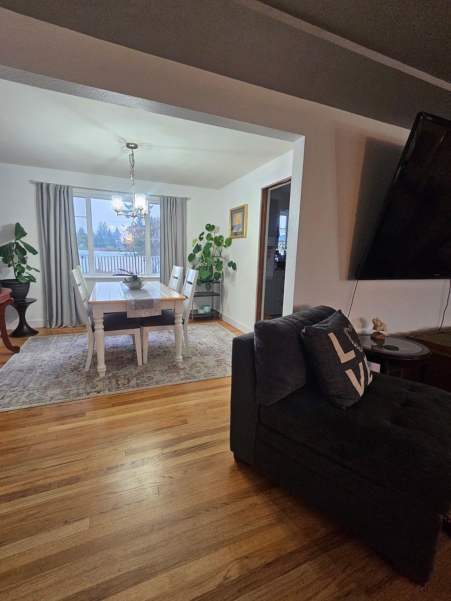 Living room looking towards dining space. Dining room looks into beautiful, landscaped backyard great for early morning sunrises as it shines through the window.