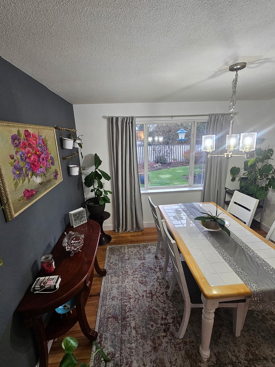 Dining room looks into beautiful, landscaped backyard great for early morning sunrises as it shines through the window.