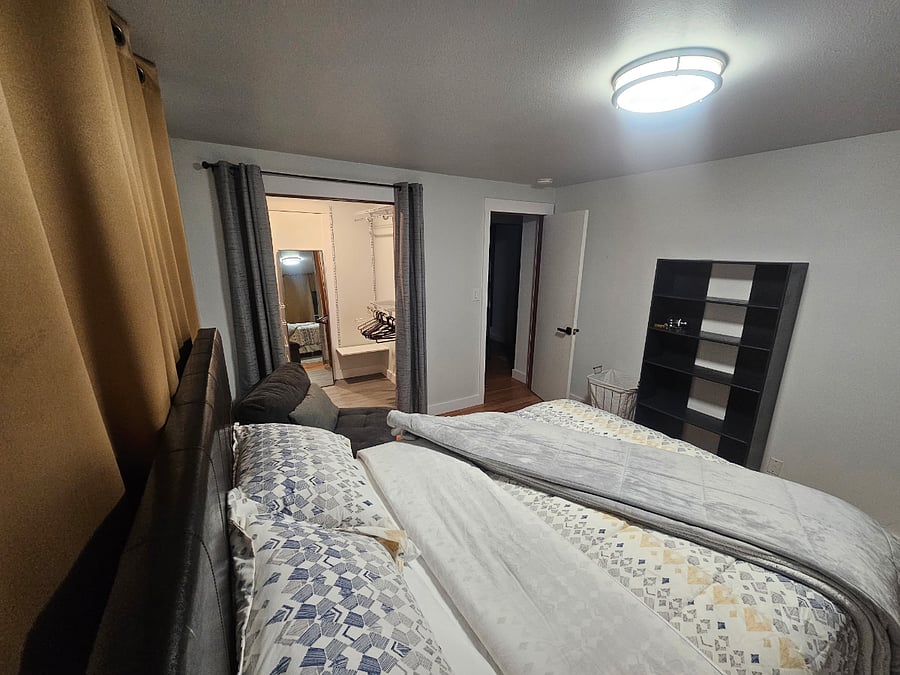 Unit A - Master bedroom with queen bed and walk-in closet.