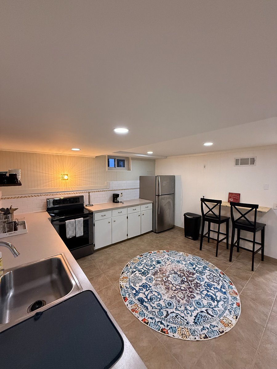 Full kitchen with modern appliances, plenty of counter space, and dining area for two.